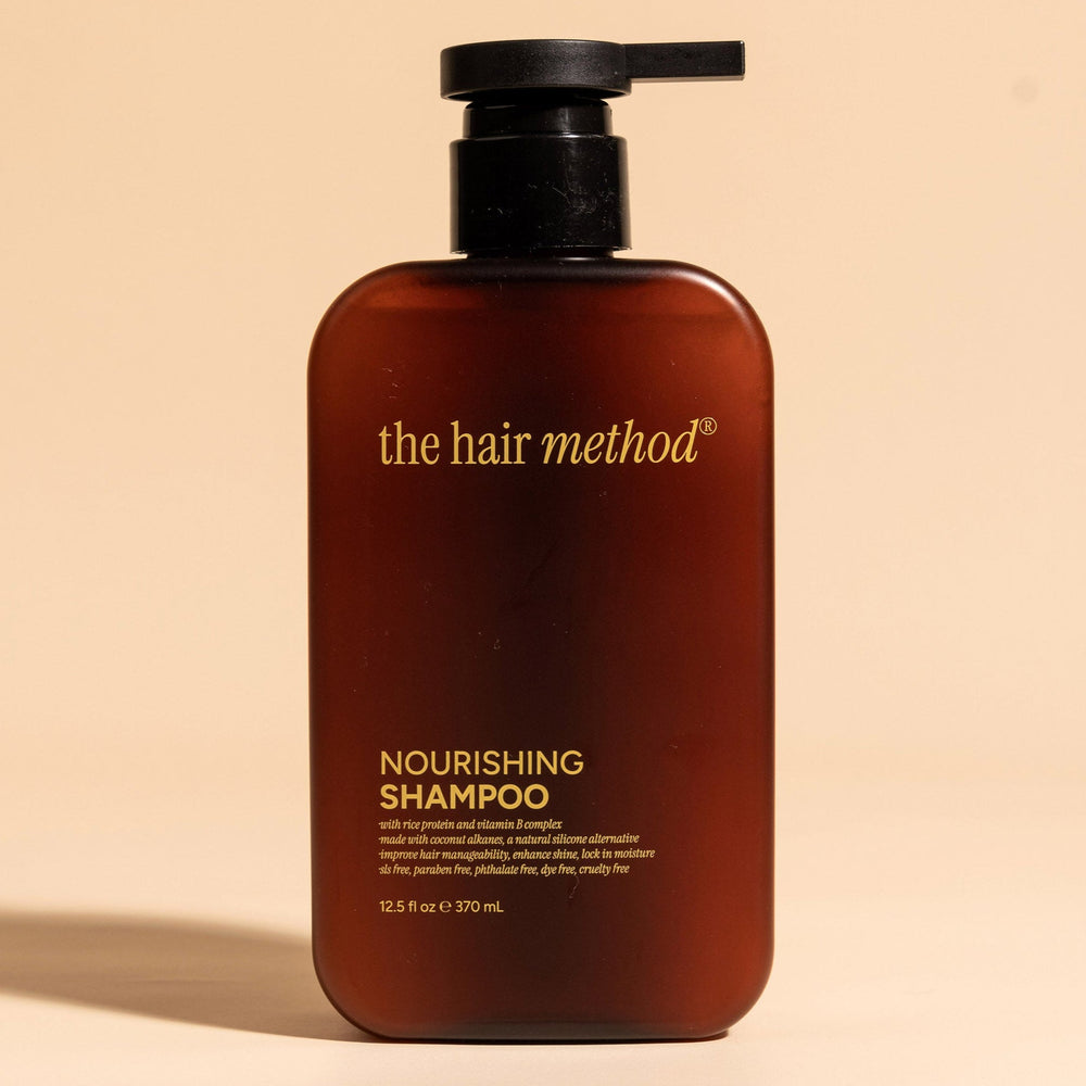 brown cosmetic bottle with black pump on a white background. 