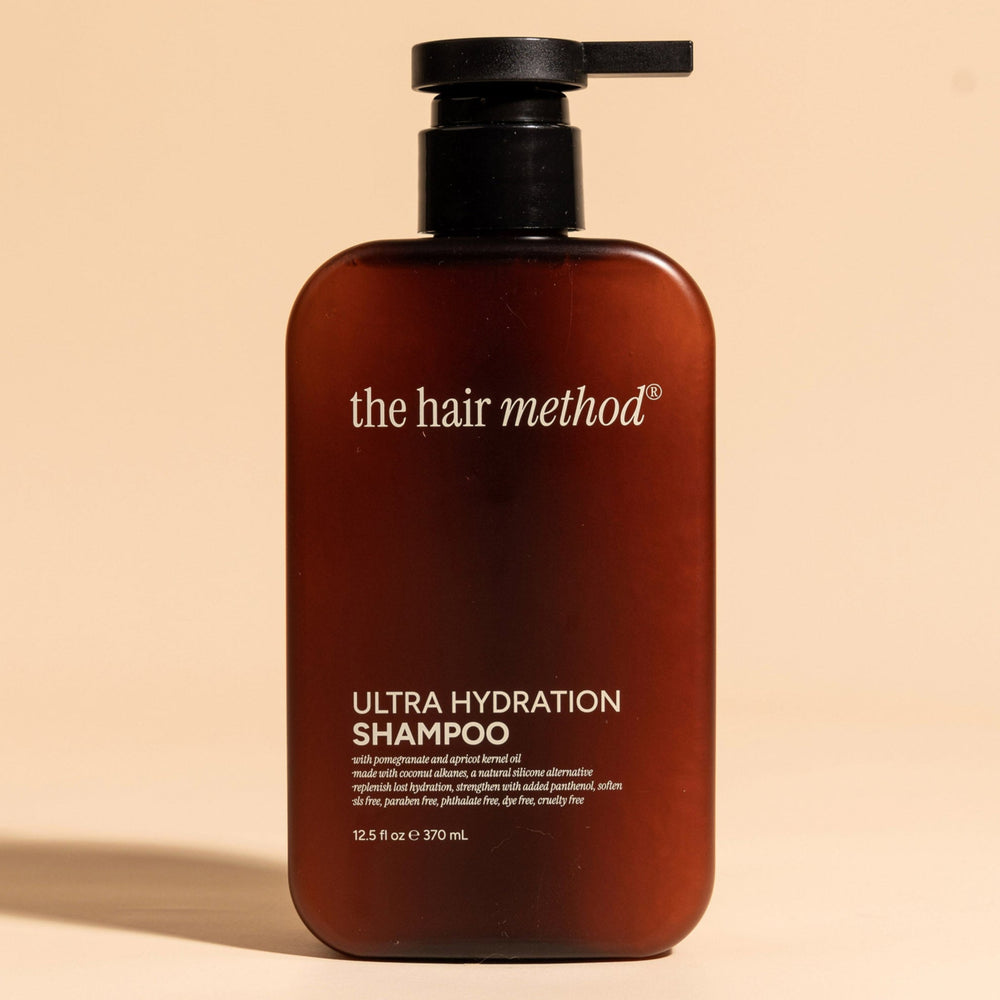 brown cosmetic bottle with black pump on a white background. 