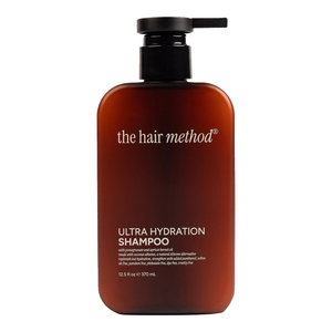 Brown shampoo bottle with black pump labeled 'the hair method' on a white background