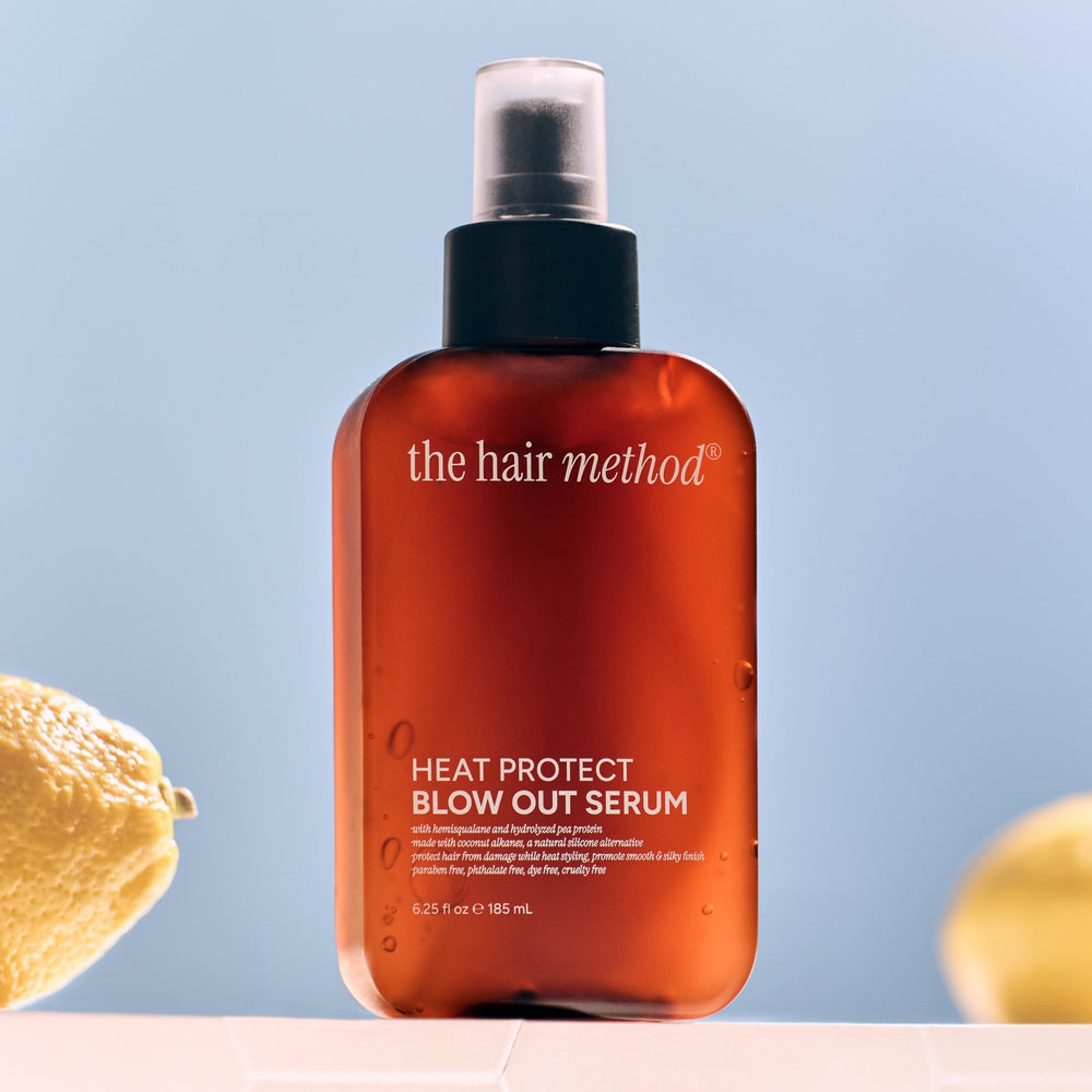 Brown bottle of 'the hair method' heat protect blowout serum on a white background