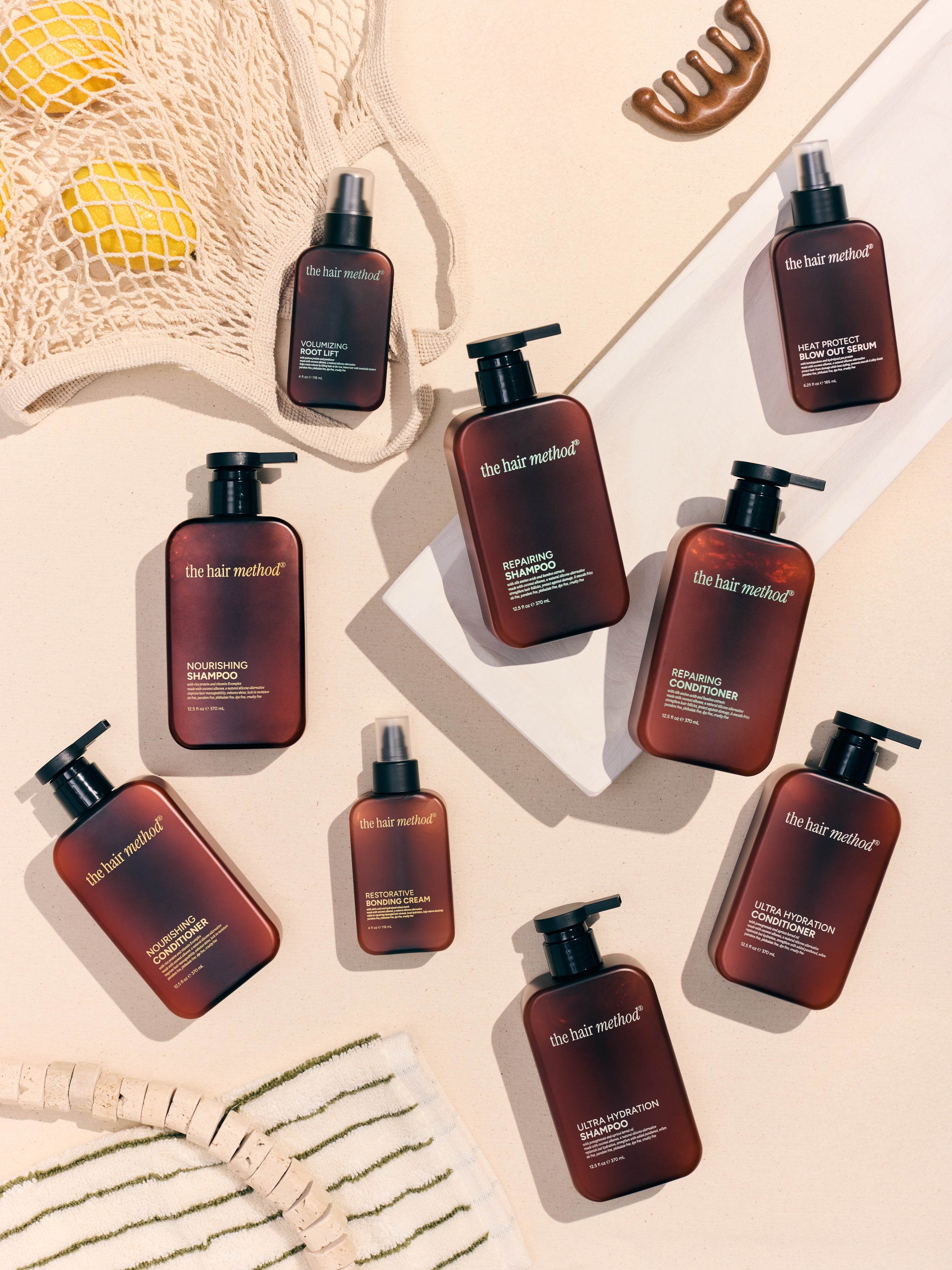 Collection of 'The Hair Method' hair care products on a beige background
